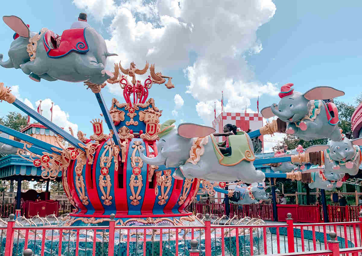 amusement park ride that has toy elephants revolving around a central axis