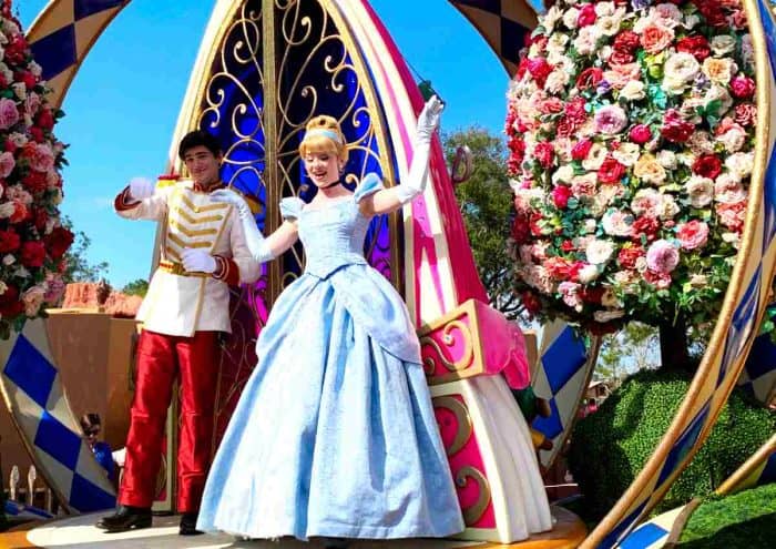 Cinderella and Prince Charming aboard a float in the Festival of Fantasy parade at Magic Kingdom