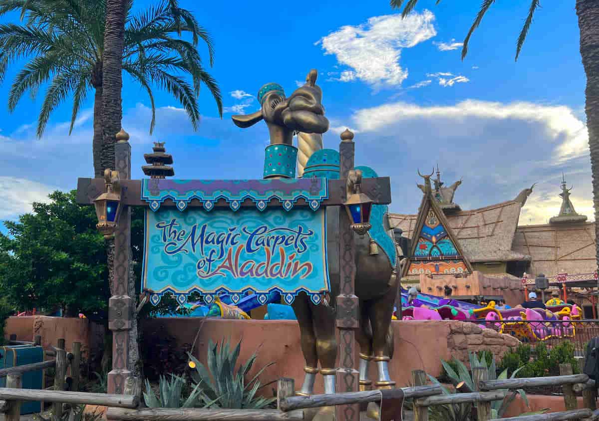Sign in front of a Magic Kingdom ride reading Magic Carpets of Aladdin