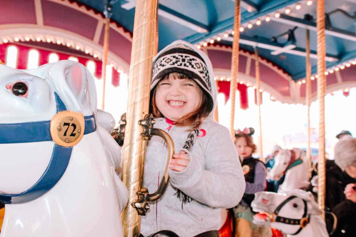 Toddler on a ceramic horse as part of a revolving carousel ride